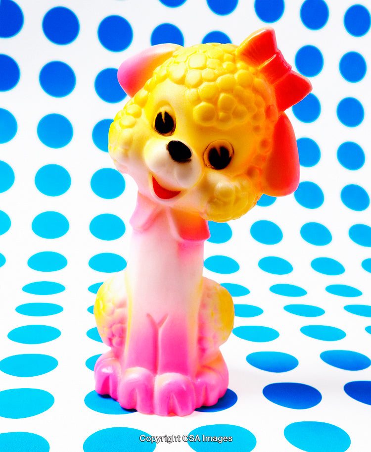Colorful Vintage Plastic Toy of a Dog with Polka Dot Background