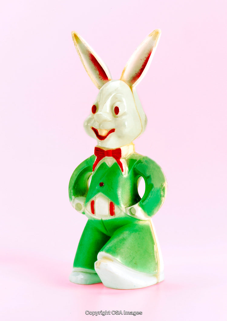 Colorful Plastic Bunny Toy Against a Soft Pink Background