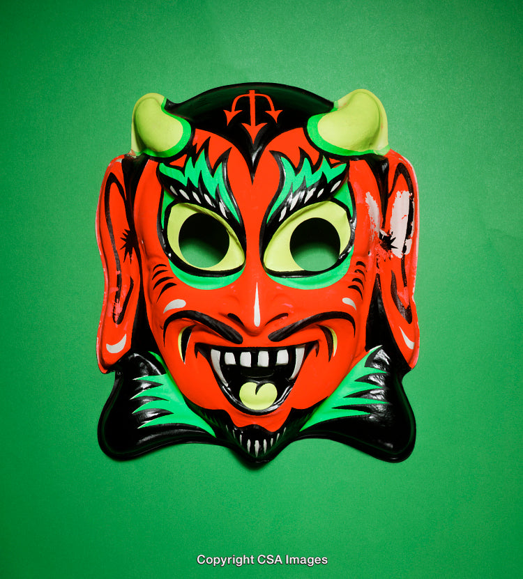 Colorful Mask of a Devil Style Face on a Green Background
