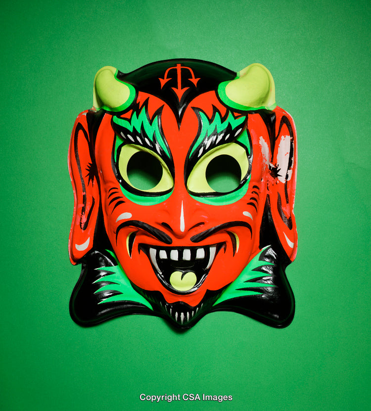 Colorful Mask of a Devil Style Face on a Green Background
