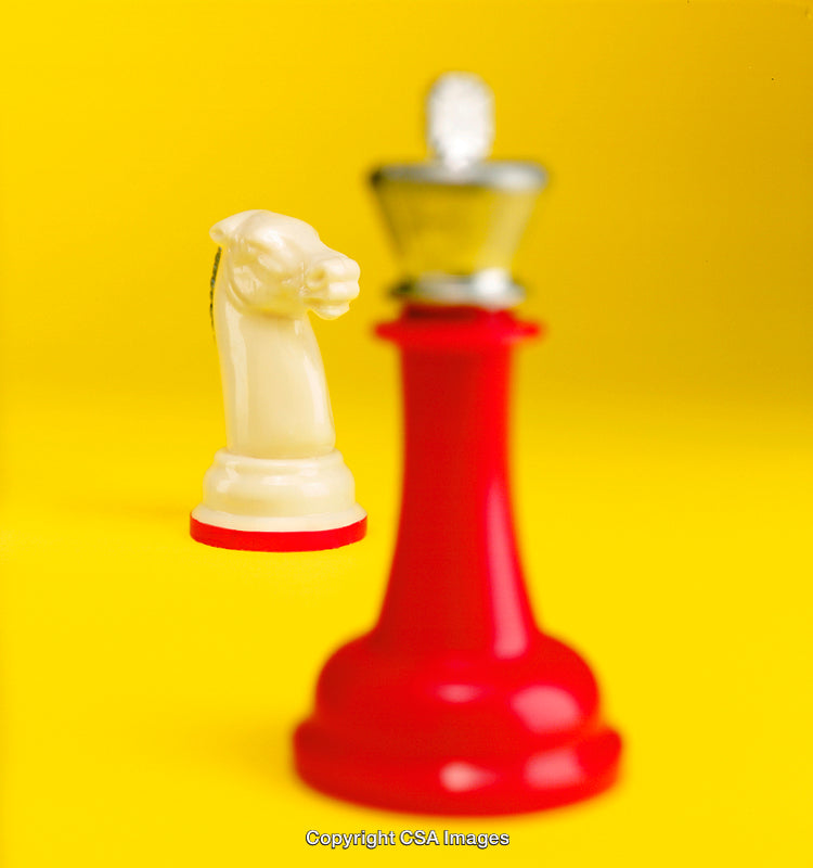 Colorful Chess Pieces Highlighted on a Bright Yellow Background