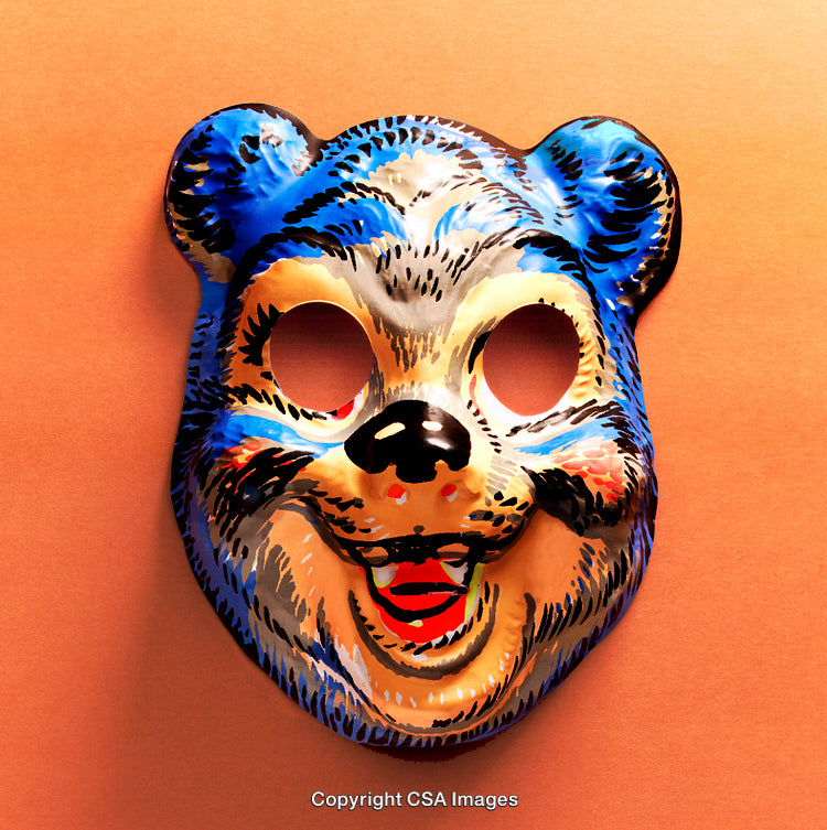 Vintage Plastic Bear Mask on Vibrant Orange Background for Playful Concepts