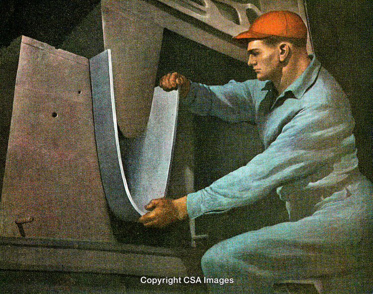 Industrial Worker Performing Metal Bending Process on Manufacturing Machinery