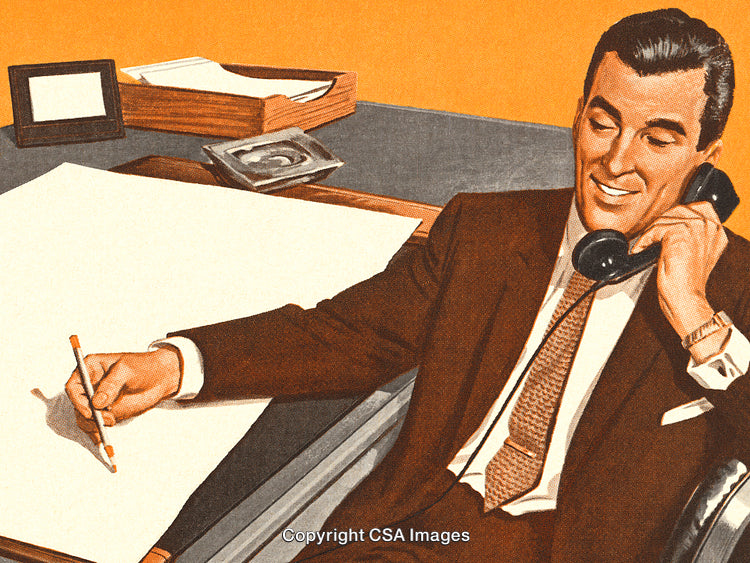 Professional Man at Work Writing and Talking on the Telephone
