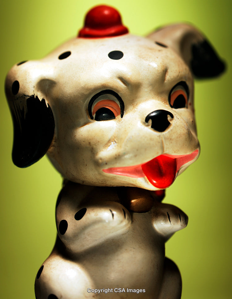 Vintage Spotted Dog Figurine with Cheerful Expression on Artistic Background