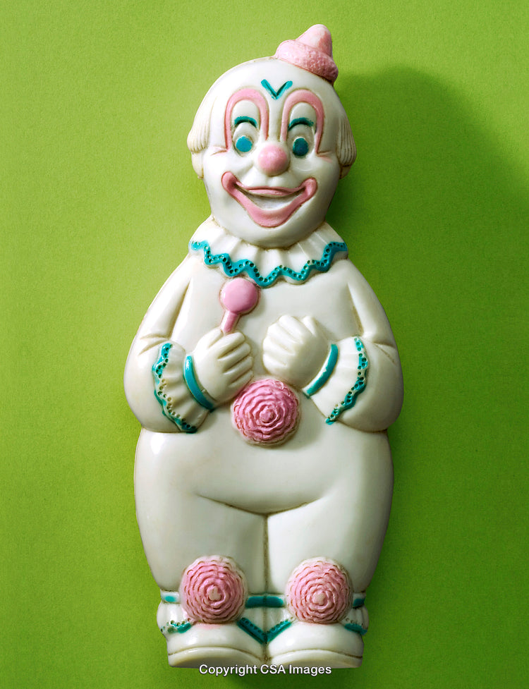 Colorful Vintage Clown Figurine on Vibrant Green Background