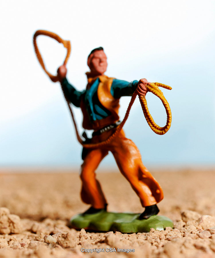 Plastic Cowboy Toy Figurine Holding a Lasso in a Desert Setting