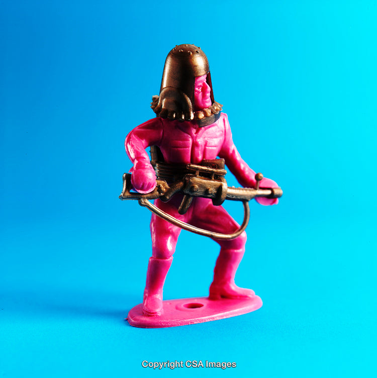 Vibrant Pink Plastic Toy Soldier With Golden Details on Blue Background
