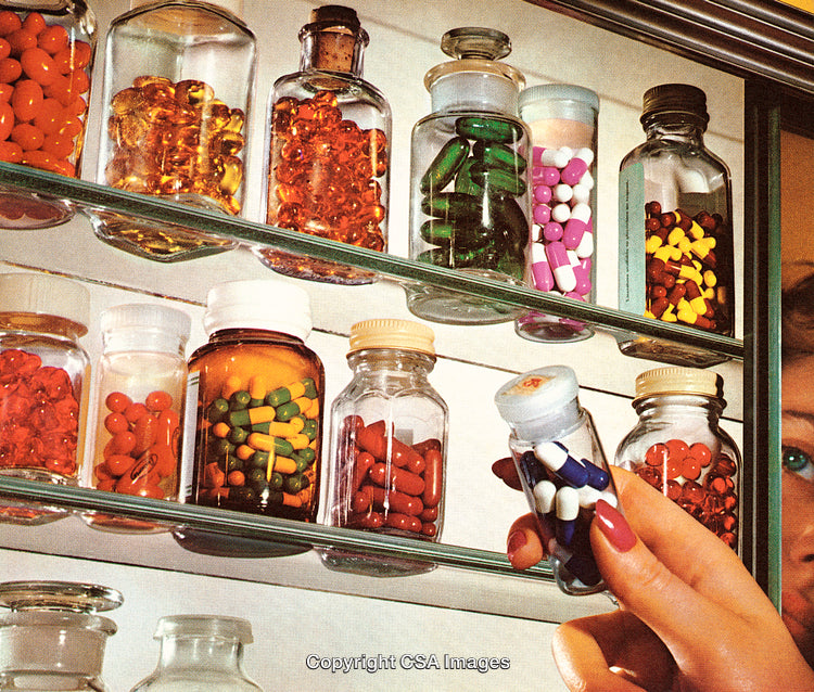 Medicine Cabinet Displaying Assorted Pills and Capsules in Glass Bottles