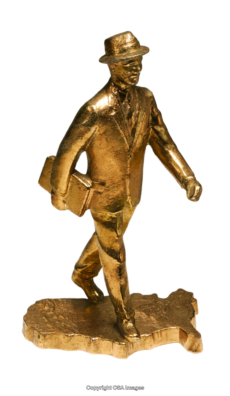 Golden Figurine of a Businessman Walking Symbolizing Progress and Leadership