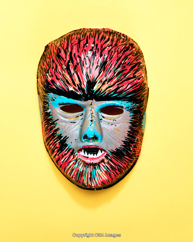 Colorful Folk-Inspired Mask Displayed Against a Bright Yellow Background