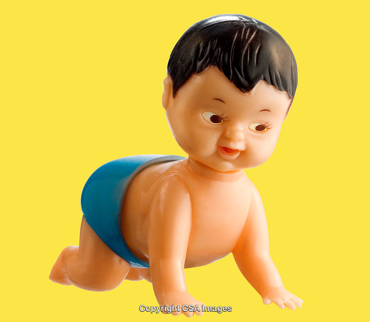 Vintage Plastic Crawling Baby Toy Against Vibrant Yellow Background