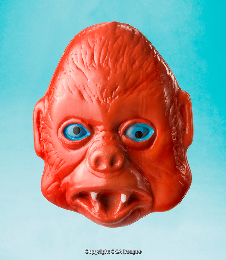Red Toy Gorilla Mask Against a Vibrant Blue Background