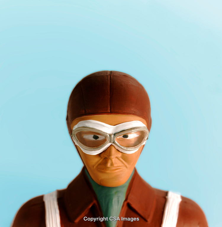 Brown-Clad Aviator Toy Figure Against Bright Blue Background