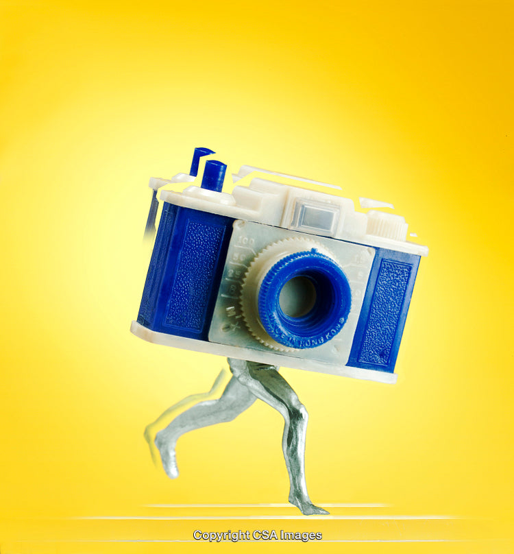 Creative Concept Featuring Toy Camera With Legs on Yellow Background