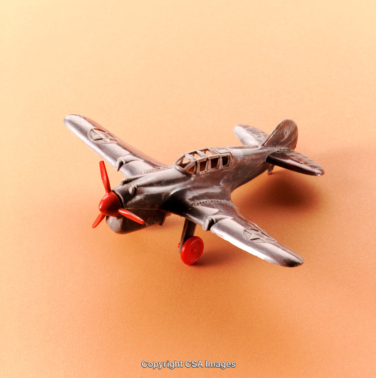 Vintage Model Airplane Toy with Red Details on Orange Background
