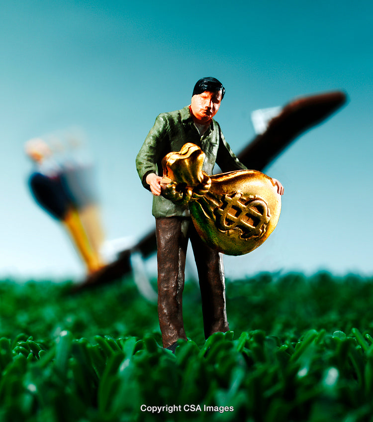 Figurine Holding Golden Money Bag With Blurred Airplane in Background