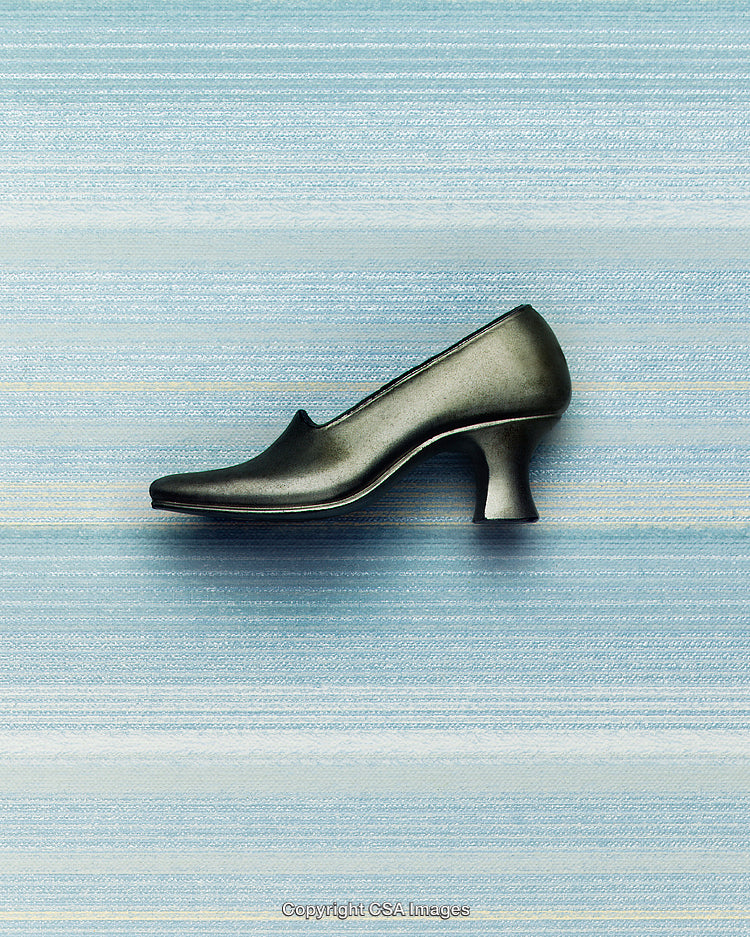 Black High-Heeled Shoe with Unique Design on Blue Background