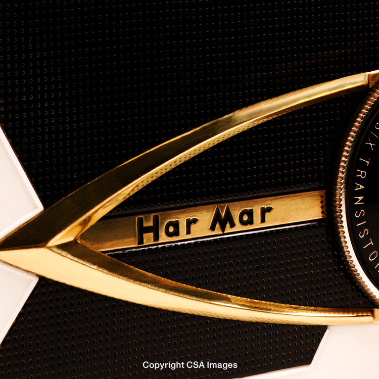 Close-Up of Retro Golden Har Mar Transistor Emblem on Textured Panel
