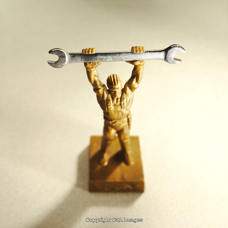 Golden Worker Figurine Holding Wrench Depicting Strength and Determination