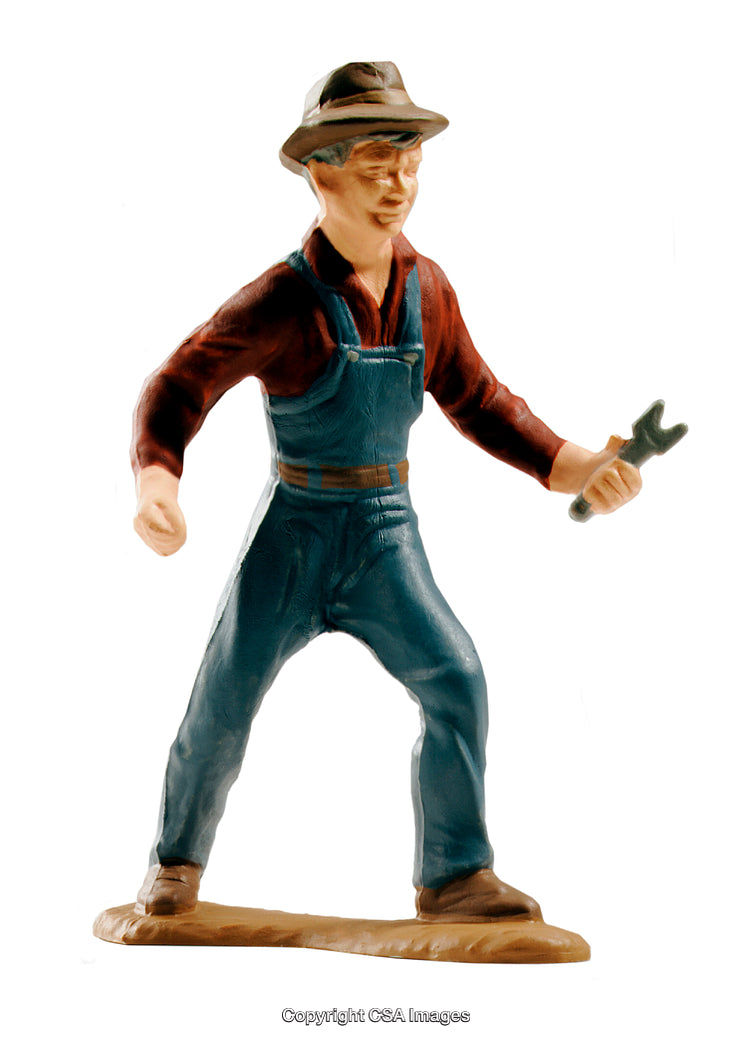 Plastic Toy of a Worker in Overalls Holding a Wrench