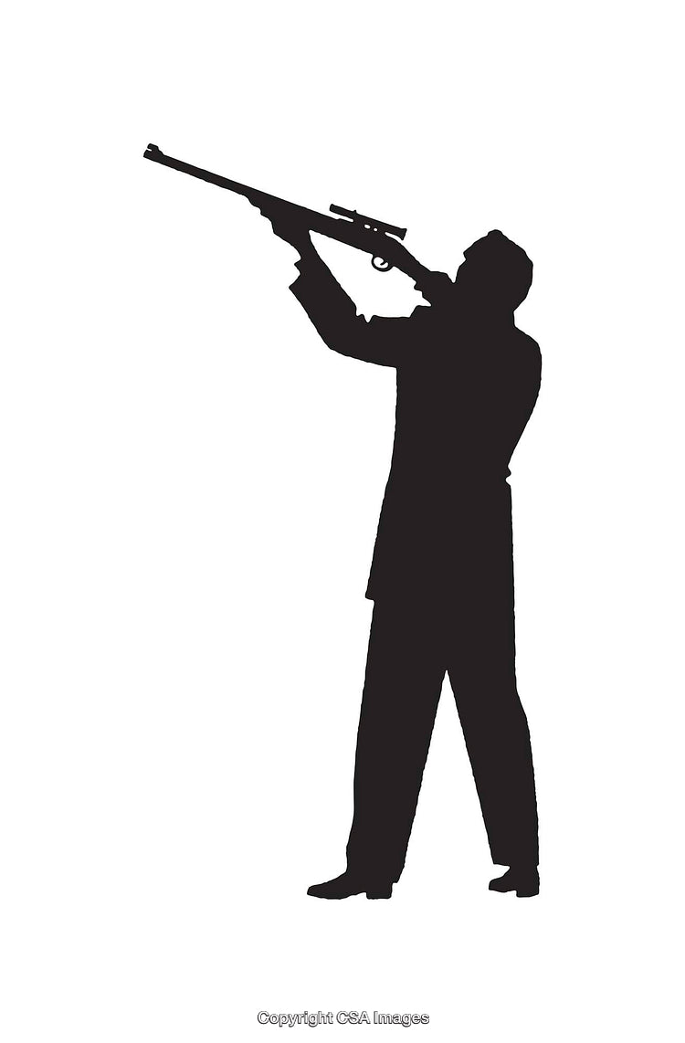 Silhouette of a Man Holding a Rifle and Taking Aim Outdoors