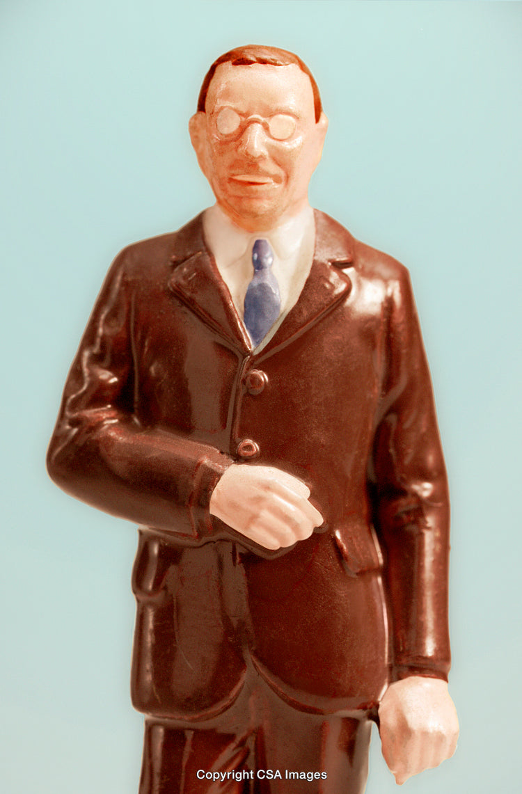 Close-Up of a Plastic Figurine Depicting a Professional in Formal Attire