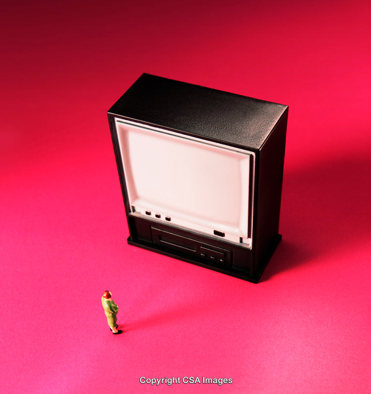 Miniature Figure Standing Beside a Large Television Against Bright Pink Background