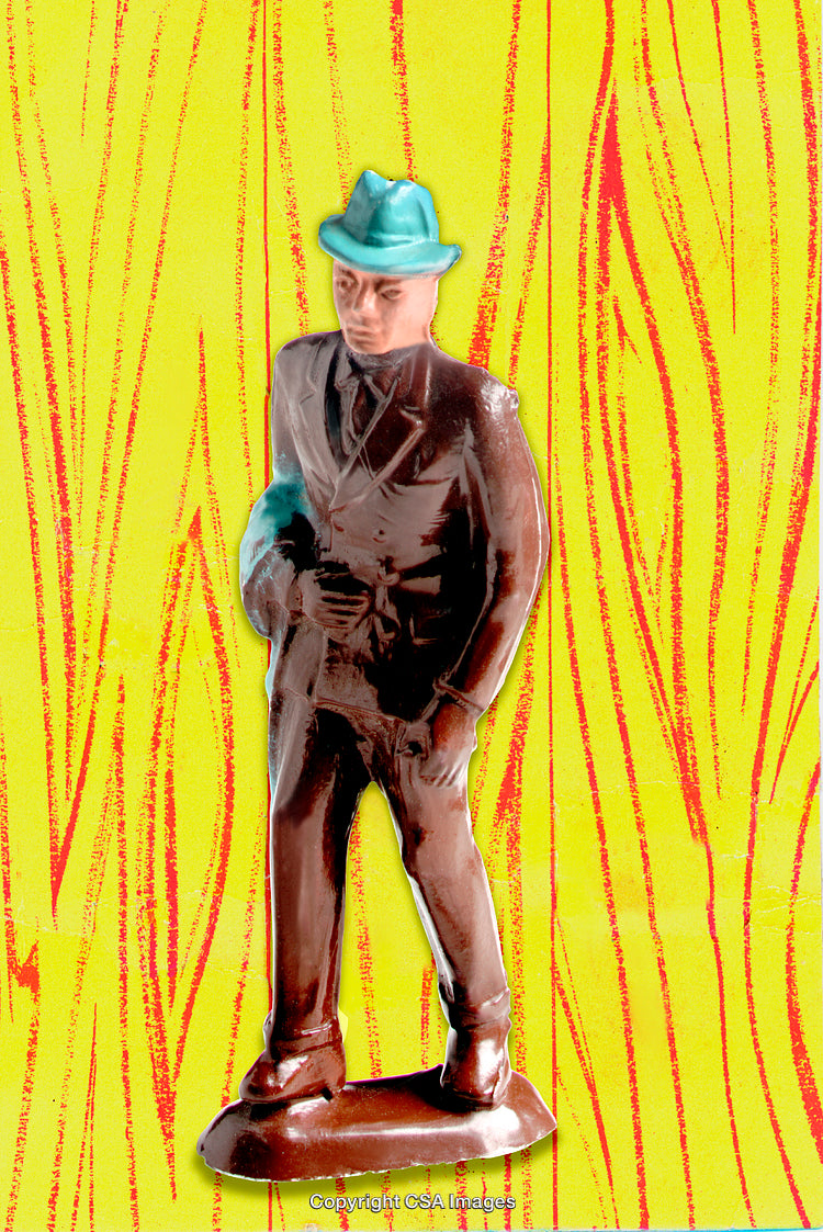 Vintage Plastic Figurine of a Man in Suit Against Bright Background