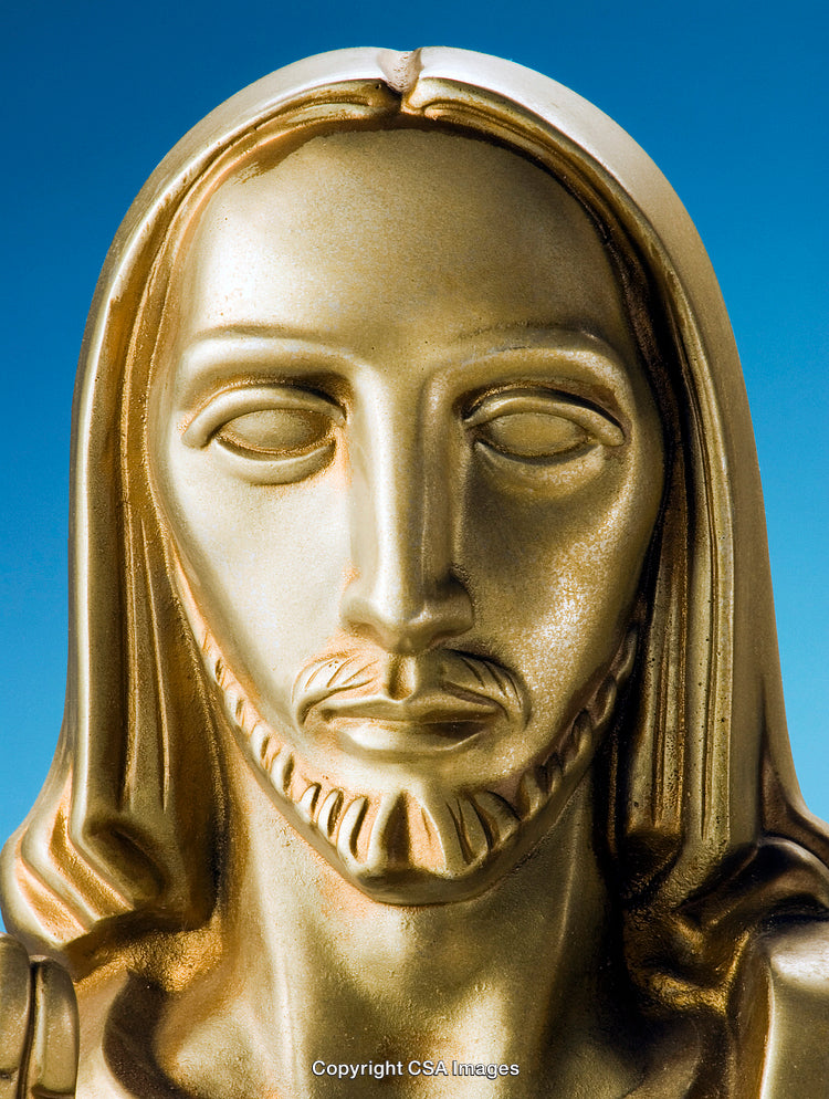 Golden Statue of a Religious Figure Against a Blue Sky