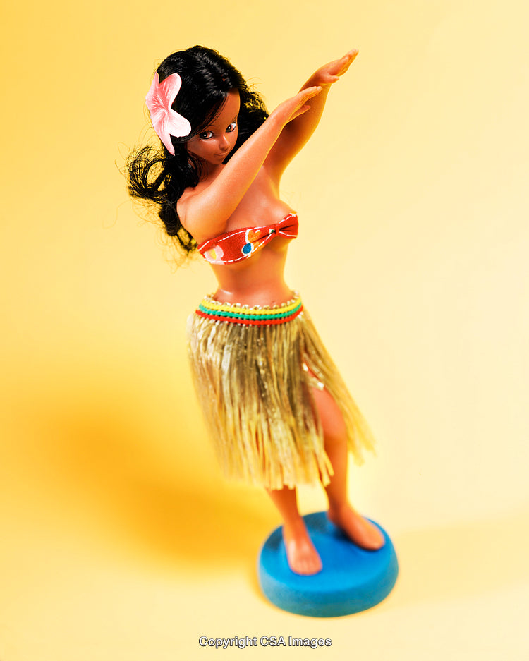 Brightly Colored Hula Girl Figurine On Yellow Backdrop