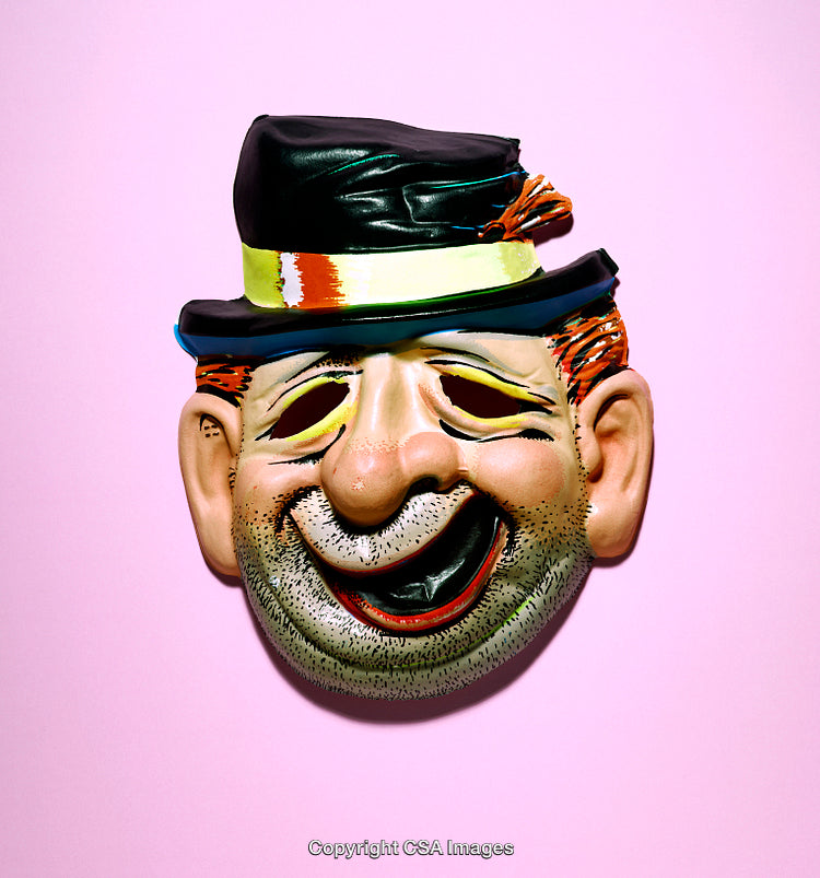 Colorful Vintage Clown Mask Against a Pink Background