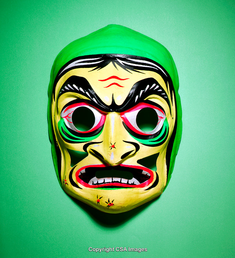 Vibrant Painted Mask on Green Background Captures Art and Expression
