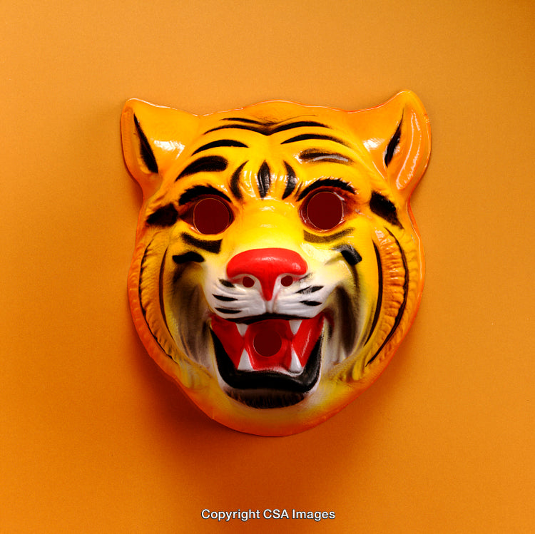 Orange Background Highlighting a Vibrant Plastic Tiger Costume Mask