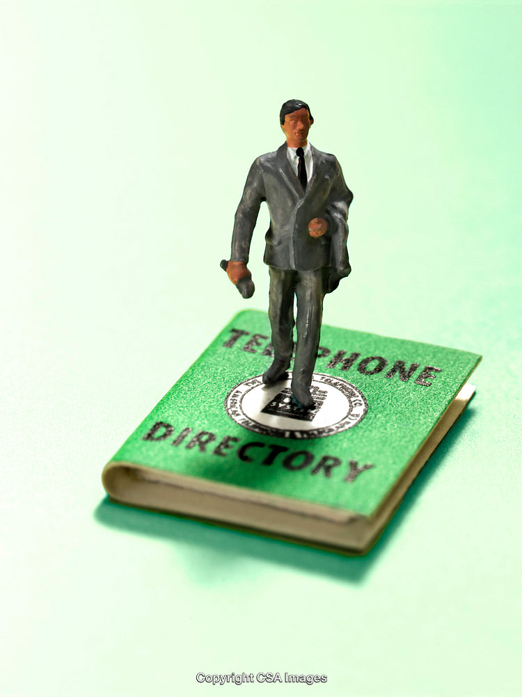 Miniature Figure On Green Telephone Directory With Abstract Background