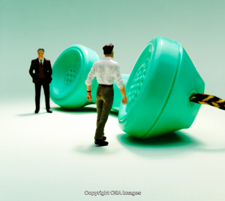 Miniature People and Large Vintage Telephone in Conceptual Scene