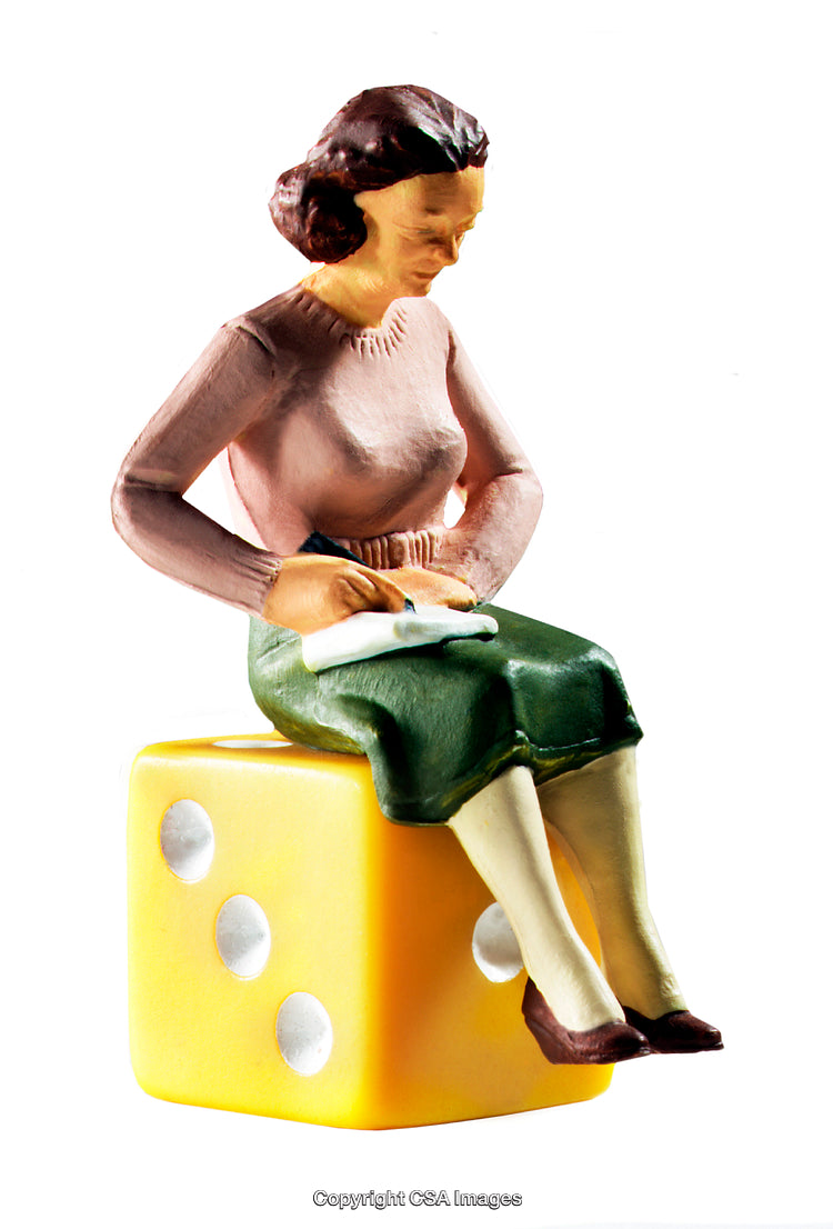 Miniature Woman Figurine Sitting on a Large Yellow Dice