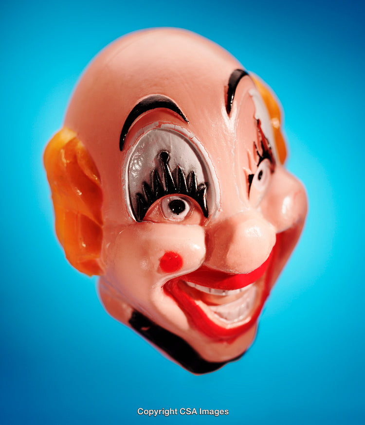 Close-Up of a Vibrant Plastic Clown Toy Against a Blue Background