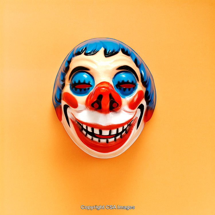 Colorful Clown Mask Against a Vibrant Orange Background