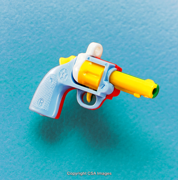 Colorful Toy Revolver Against a Vibrant Blue Background