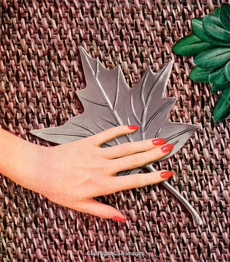 Elegant Red Nails Beside A Leaf on Textured Background
