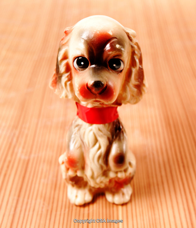 Vintage Style Dog Figurine on Wooden Surface in Warm Light