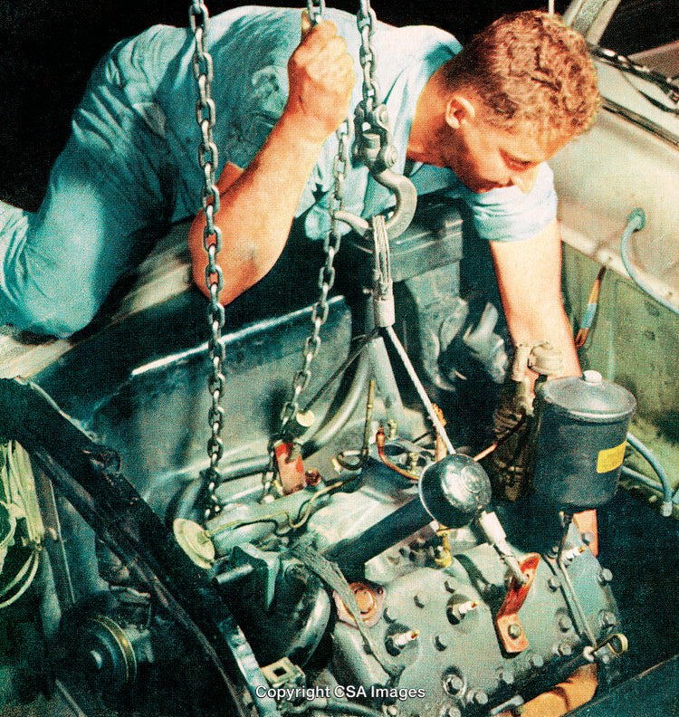 Skilled Mechanic Working on Car Engine Repair in Vehicle Workshop Environment