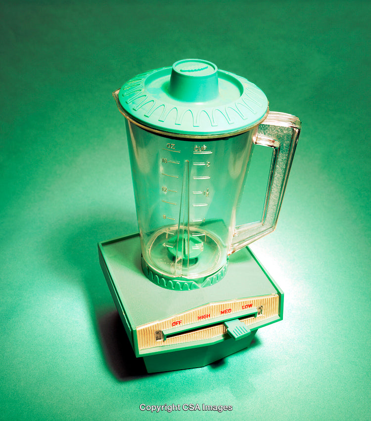 Vintage Teal Blender Toy Against a Green Background