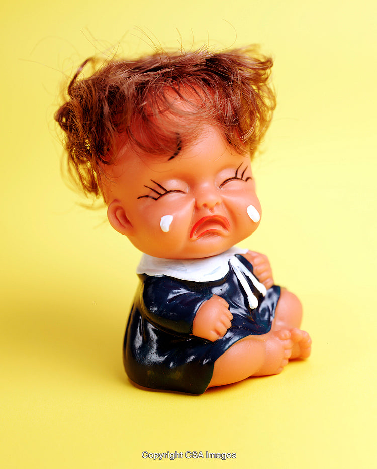 Vintage Crying Doll on Bright Yellow Background