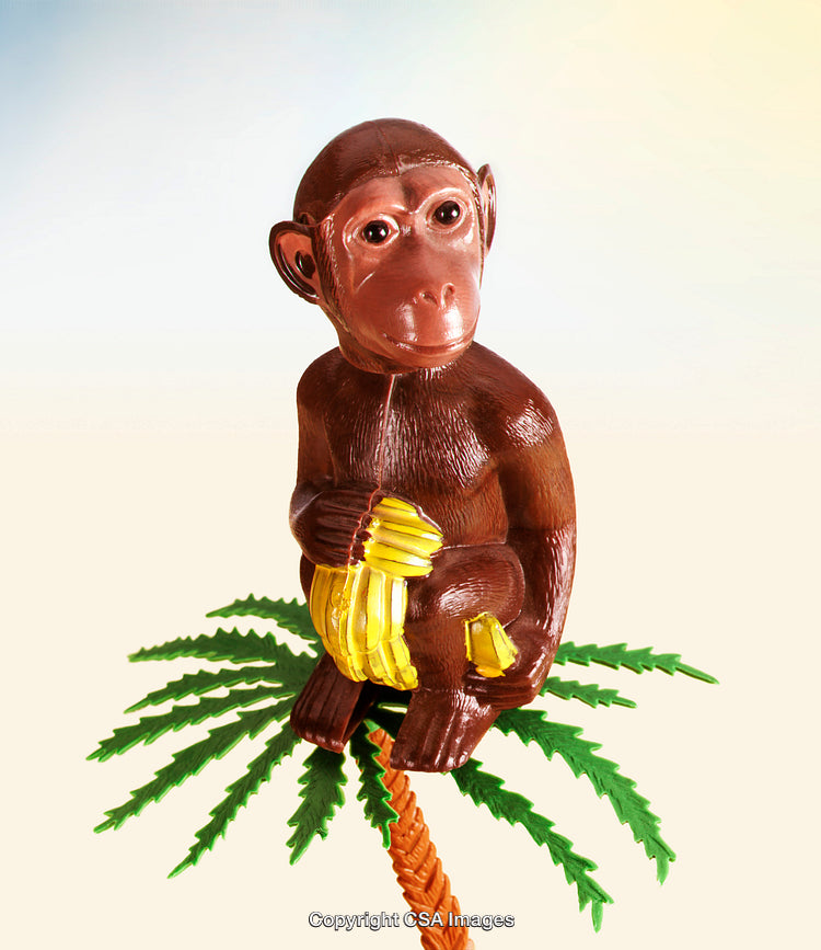 Plastic Monkey Figurine Holding Bananas on a Palm Tree