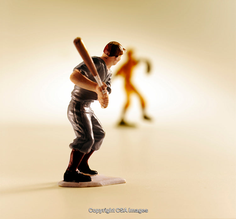 Miniature Baseball Figures in Action on a Bright Backdrop