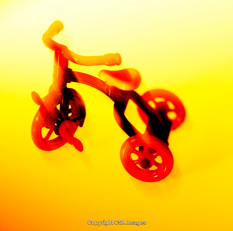 Vintage-Style Plastic Tricycle with Vibrant Colors and Abstract Lighting