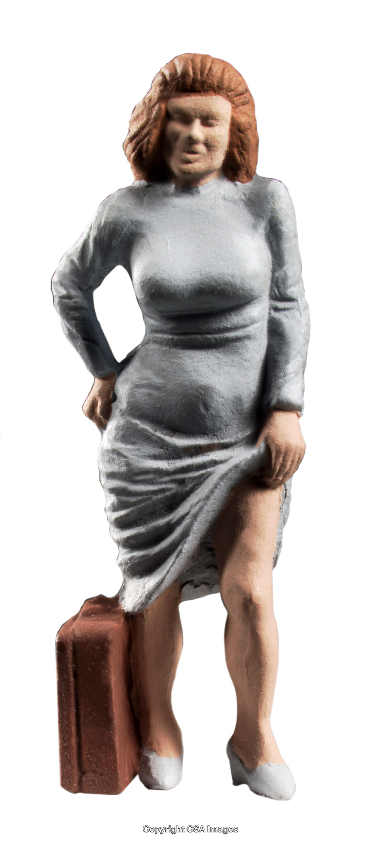 Plastic Female Figure with Luggage Against a White Background