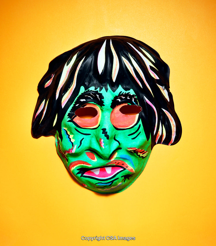 Colorful Green Monster Mask Against Bright Orange Background